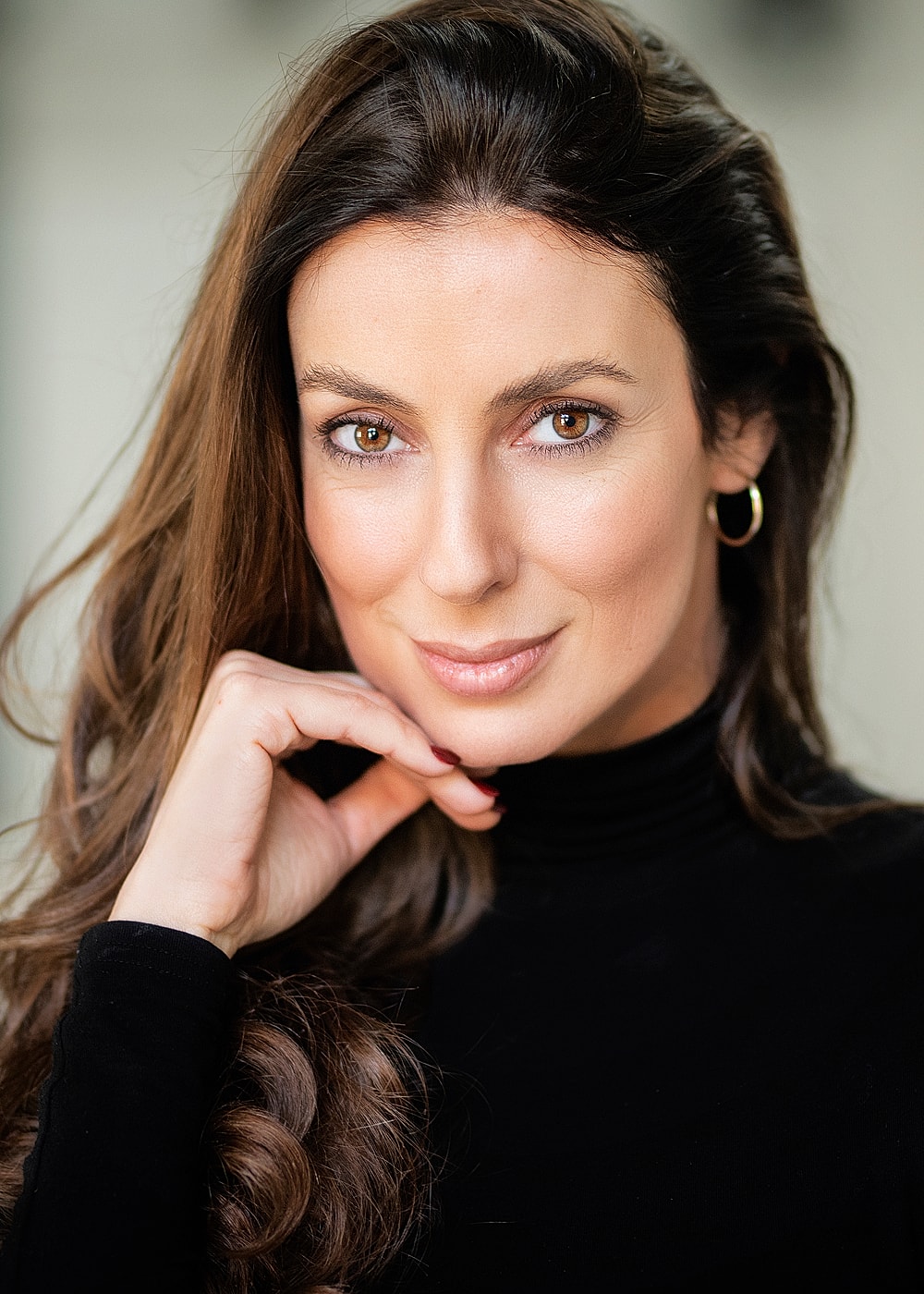 Portrait of a woman with long, dark hair.