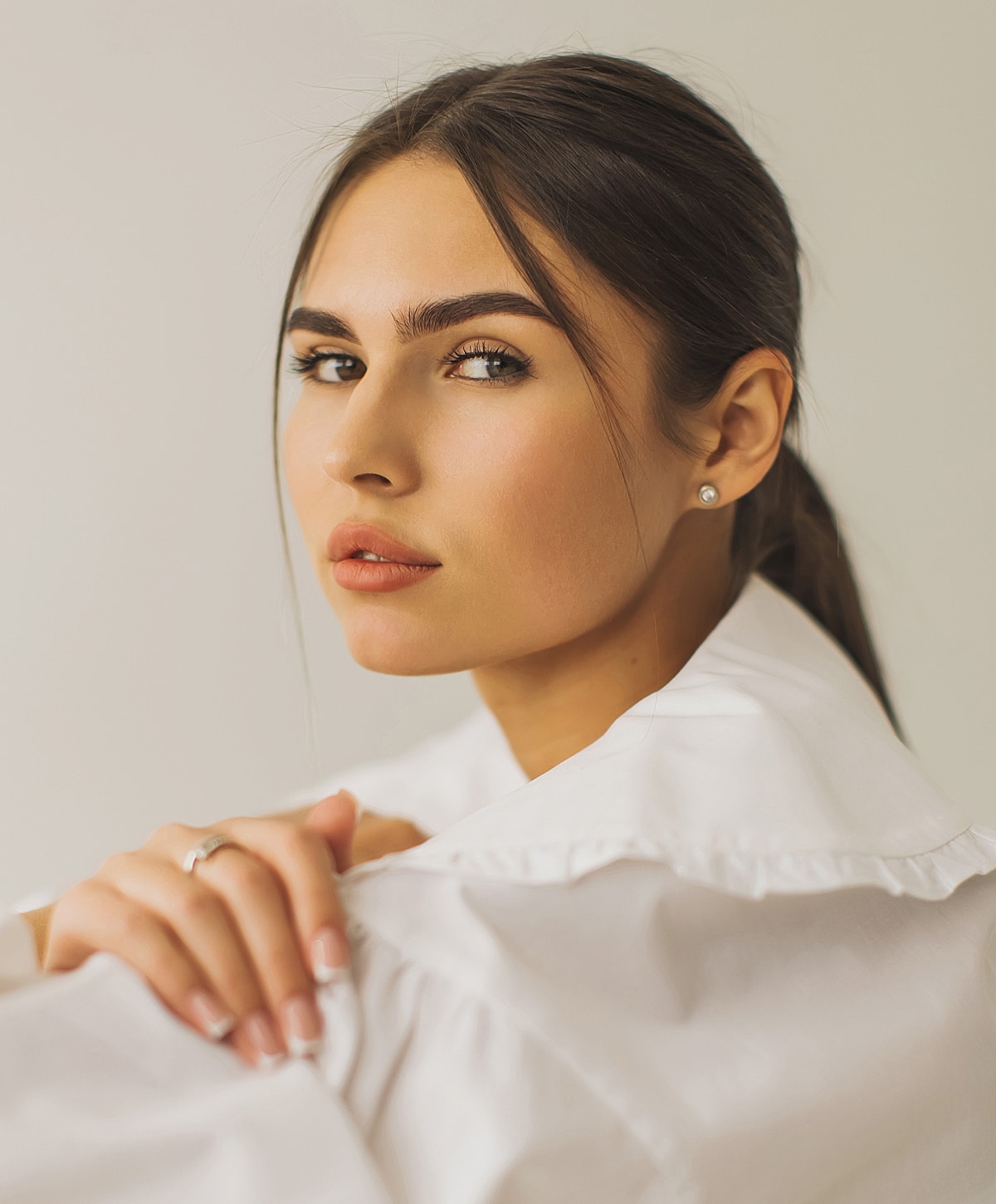 Portrait of a woman in a white shirt.