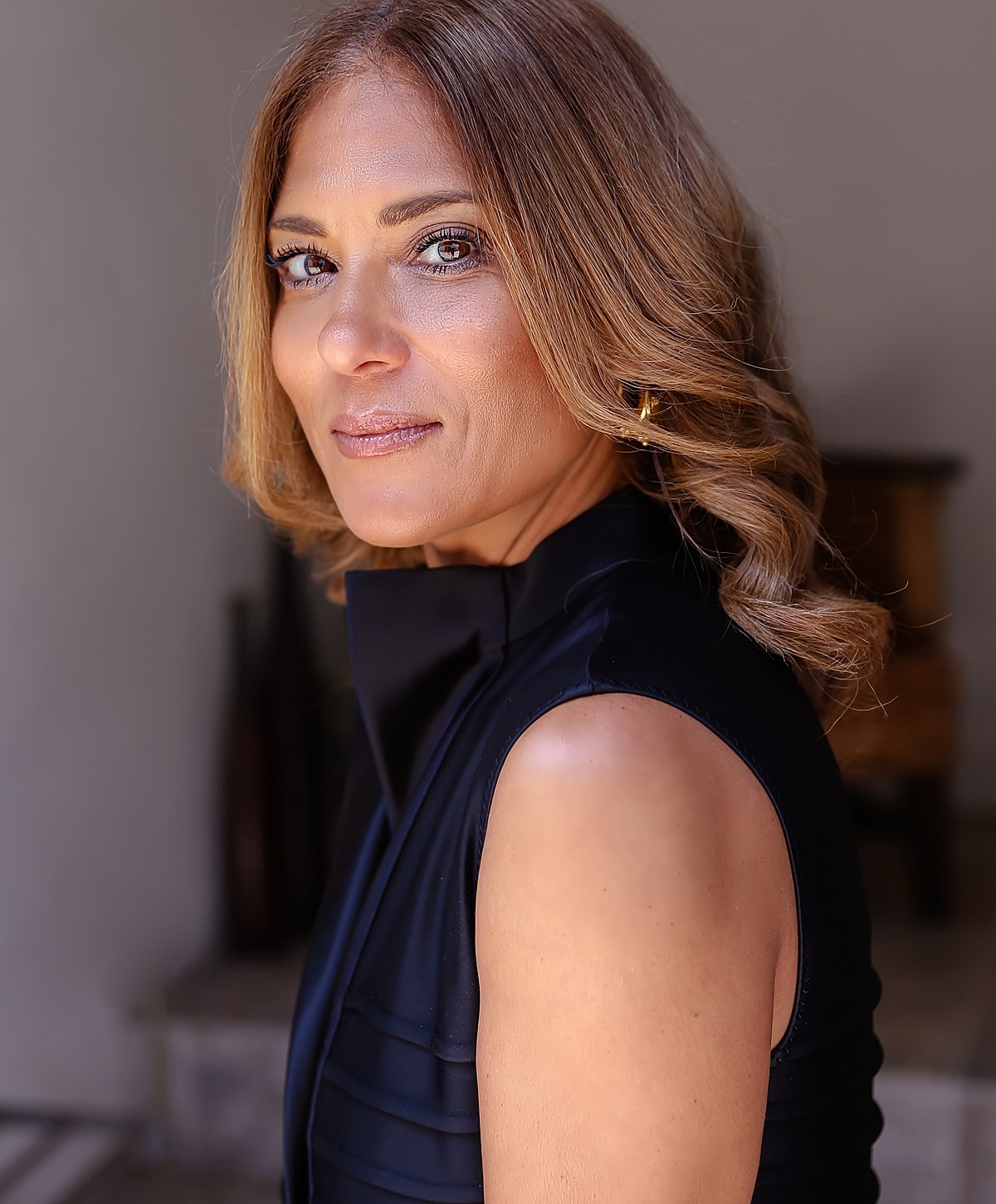 Woman with wavy hair in a stylish outfit.