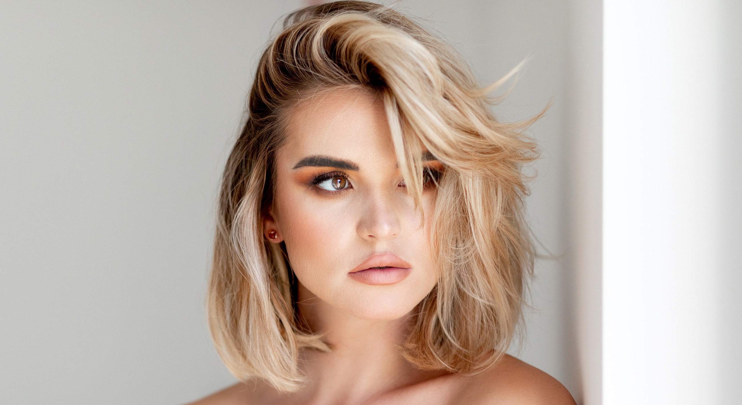 Woman with blonde hair and soft makeup.