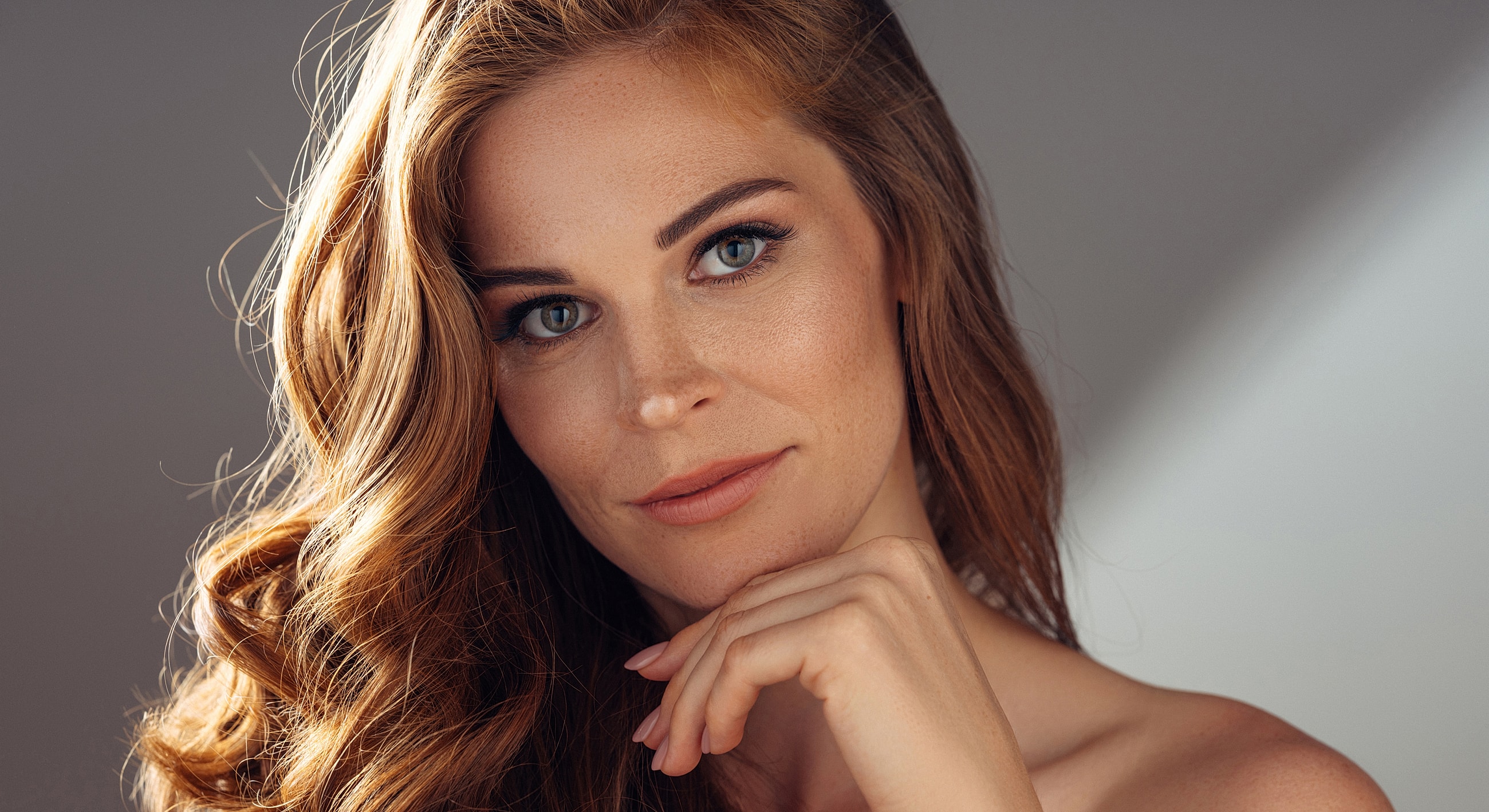 Woman with wavy hair and soft smile